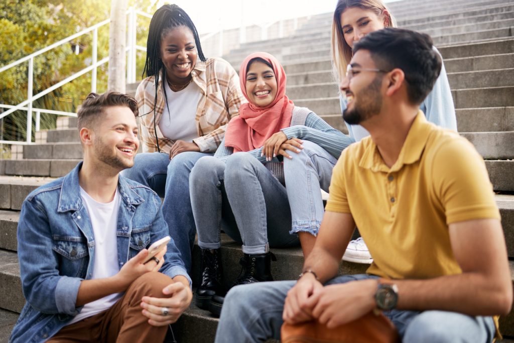 university students sitting on a set of stairs